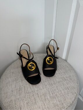 Black Leather Slingback Sandals with Gold Emblem